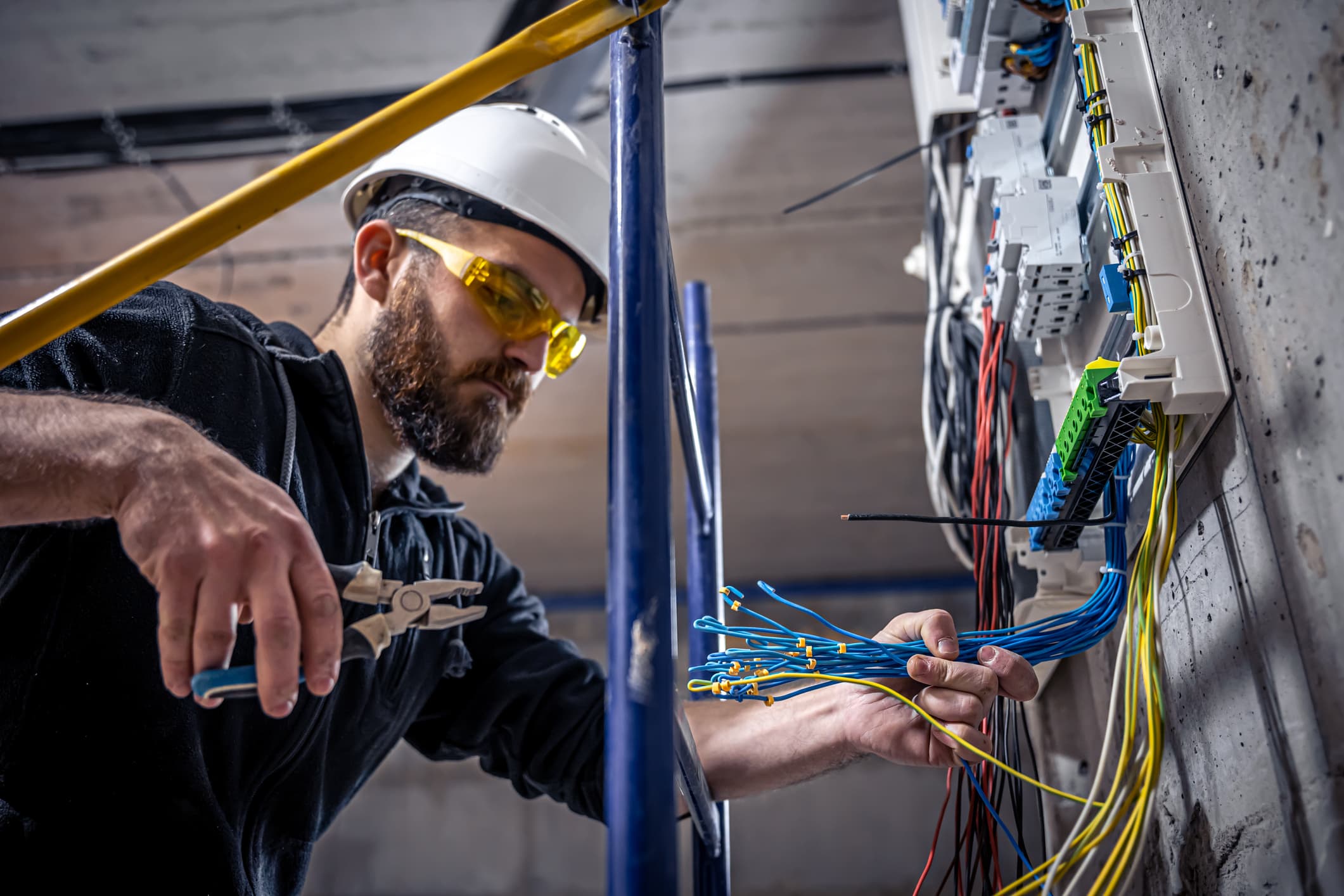 Electrician working on electrical panel